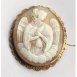 A large oval shell cameo, half length portrait of an angel with dove, the scalloped yellow metal