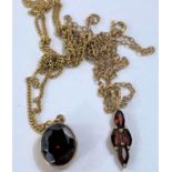 A pendant set with oval facetted garnet coloured stone in 9ct hallmarked gold surround on fine