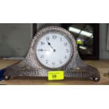 A mantel clock in beaten pewter 'Napoleon Hat' case, on ball feet, A E Jones