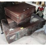A leather suitcase with old railway labels and 2 smaller suitcases
