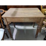 A pitch pine kitchen table with rectangular top, on turned legs