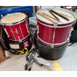 A drum kit including base and side drums with boxes; pedals; sticks; etc.