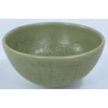 A Chinese possibly Ming period celadon glazed stoneware bowl with incised decoration and 'Greek Key