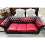A traditional Chesterfield 3 seater settee in deeply buttoned oxblood hide