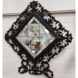 A wrought metal pierced framed bevelled edge wall mirror height 47cm