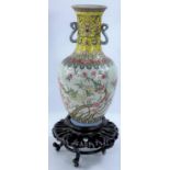 A Chinese Republic period porcelain vase of baluster form, with loop handles, decorated in the