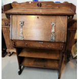 An Arts & Crafts oak bureau with fall front and open shelves under