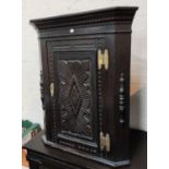 A 19th century carved oak corner cupboard with straight front; a similar firescreen