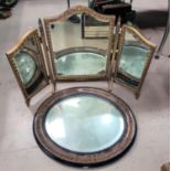 An Edwardian oval wall mirror in wood effect frame; a triple dressing table mirror, gilt framed;