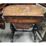 A Victorian quarter veneered walnut worktable with hinged rounded rectangular top, writing slide and
