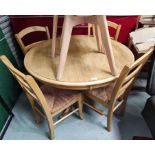 A lightwood kitchen dining suite comprising pedestal table with circular top and 4 chairs with