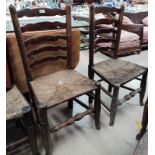 A pair of 19th century rush seat ladder back dining chairs