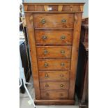 A yew wood gun cabinet in the form of a 19th century Wellington chest enclosed by door with 7