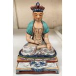 A Chinese ceramic figure of a Buddha in seated lotus position with hole to back possibly for wall