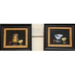 A 20th century still life of 1/2 a lemon, cherry & a vase/cup, a pair of oils on board, signed