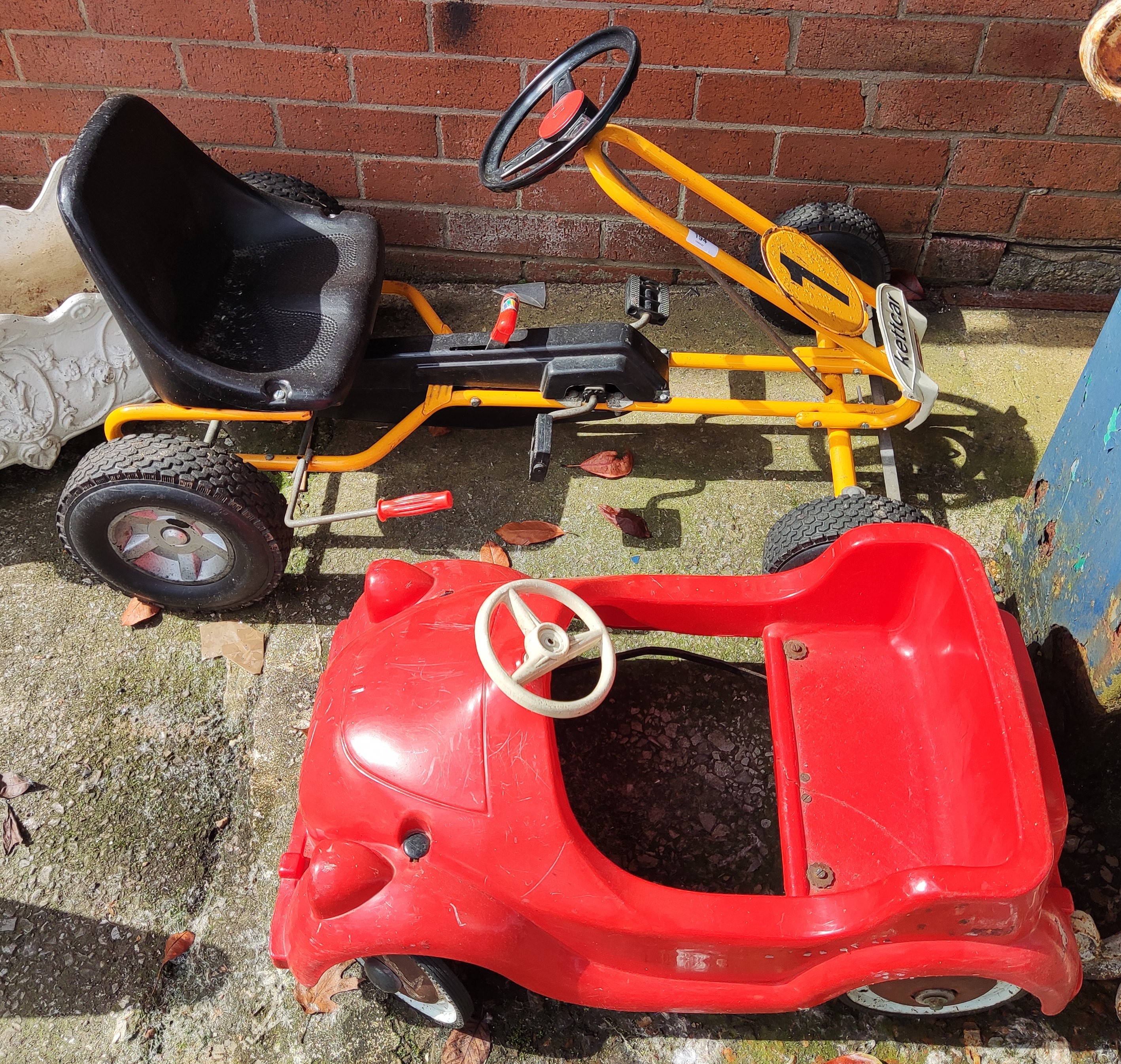 A Kettcar Hockenheim go cart (some wear / rust to number) and a red toy car (seat cracked)