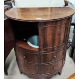 A 19th century mahogany demi-lune commode with hinged top, double doors, false fascias, and original