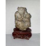 A Chinese carved jade figure of mother and child, 64mm, with stand (good condition)