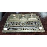 A 19th century brass double desk set with inkwells and central stamp section under hinged lids