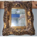 A wall mirror in heavy gilt frame; various pictures; reproduction advertising posters