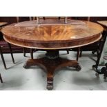 An early 19th century circular figured mahogany tilt top supper table on turned and carved