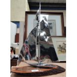 An Art Deco chrome yacht on polished wood base, 50cm height