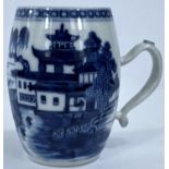 A late 19th/early 20th century Chinese porcelain barrel shaped mug decorated in unglazed blue with