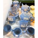 A large selection of Wedgwood blue jasperware teaware:  tea and coffee pots, cups and saucers; etc.