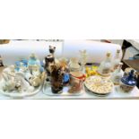 A selection of decorative pottery including Wade pigs; Bells decanters; musical dog decanters,