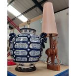 A large blue and white baluster lamp base and a carved antelope lamp