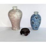 A Chinese porcelain ovoid snuff bottle decorated in red and blue, 6.5cm, hardwood stand and a