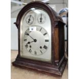An oak cased bracket clock, c. 1900, silvered dial, domed top with carry handle, key and pendulum