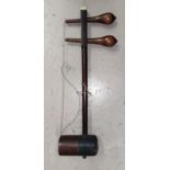 An Erhu (Chinese Violin) in stained wood with two strings, snake skin back (split)
