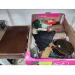 A small fitted leather suitcase; small Persian hand knotted mats; fans; packs of cards; etc.