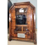 An Art Deco oak cased smokers cabinet with plaque with ceramic tobacco jar