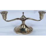 A hallmarked silver, two branched candelabra of squat form, Sheffield 1962, weighted base.