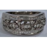 A 9 carat hallmarked white gold dress ring with multiple diamonds in intricate setting, 5 gm, size N