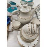 A Susie Cooper part tea service gilt stars turquoise interior, 6 cups and saucers, milk jug and bowl