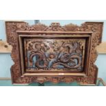 A Chinese carved panel depicting 2 dragons, in stained and pierced wood, 72 x 53 cm