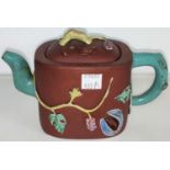 An early 20th century Yixing teapot with coloured handle and spout with relief decoration of