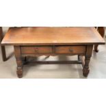 An oak 2 tier coffee table with rectangular top and 2 frieze drawers, on turned legs