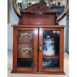 Late 19th/early 20th century smoking cabinet with tobacco jar, glazed doors and pipe rack above