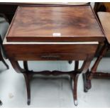 A 19th century figured mahogany writing/work table with hinged top, fitted interior and X framed