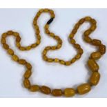 A vintage butterscotch bead necklace, gross weight 142gm