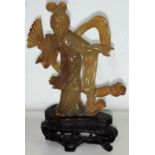 A carved Chinese agate coloured female figure on wooden stand height 11.5cm