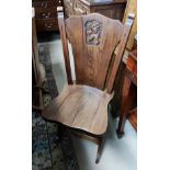 A set of 6 solid oak dining chairs, the panel backs with lions rampant carving, solid seats, on