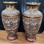 A pair of Doulton Lambeth stone ware vases, swirling floral relief gilt and brown, marked AD