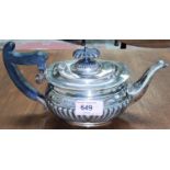A hallmarked silver batchelor's tea pot with ebonised handle, ribbed body, Sheffield 1912, 14oz