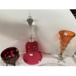 A large circular glass cheese cover, 27cm, a cranberry glass bell, 33cm and 2 other pieces of