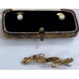 A pair of yellow metal and seed pearl cufflinks stamped 925 and a yellow metal brooch with central